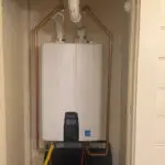 Tankless water heater installed in closet with neat copper piping in Southeast Louisiana home