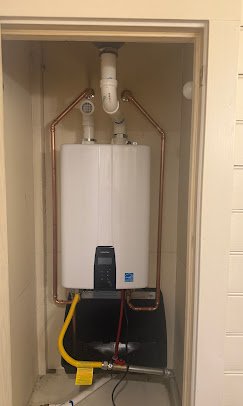 Tankless water heater installed in closet with neat copper piping in Southeast Louisiana home