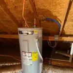 New electric water heater installed in an attic by Serrano's Plumbing Services
