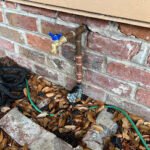 South Shore main water line and hose bib plumbing repair showing exterior pipe connections serviced by Serrano’s Plumbing Services