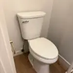 Toilet installation in a residential bathroom in South Shore Louisiana home